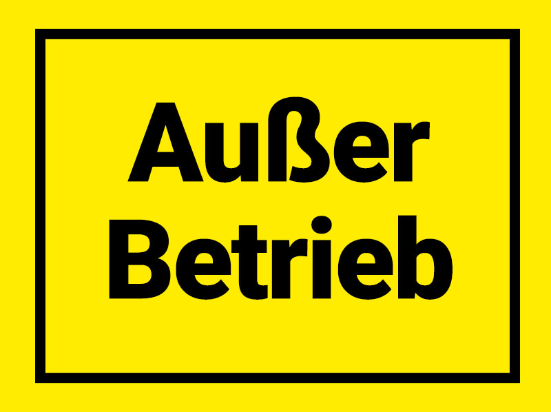Gelbes Warnschild mit schwarzem Rahmen und der Aufschrift „Außer Betrieb“.